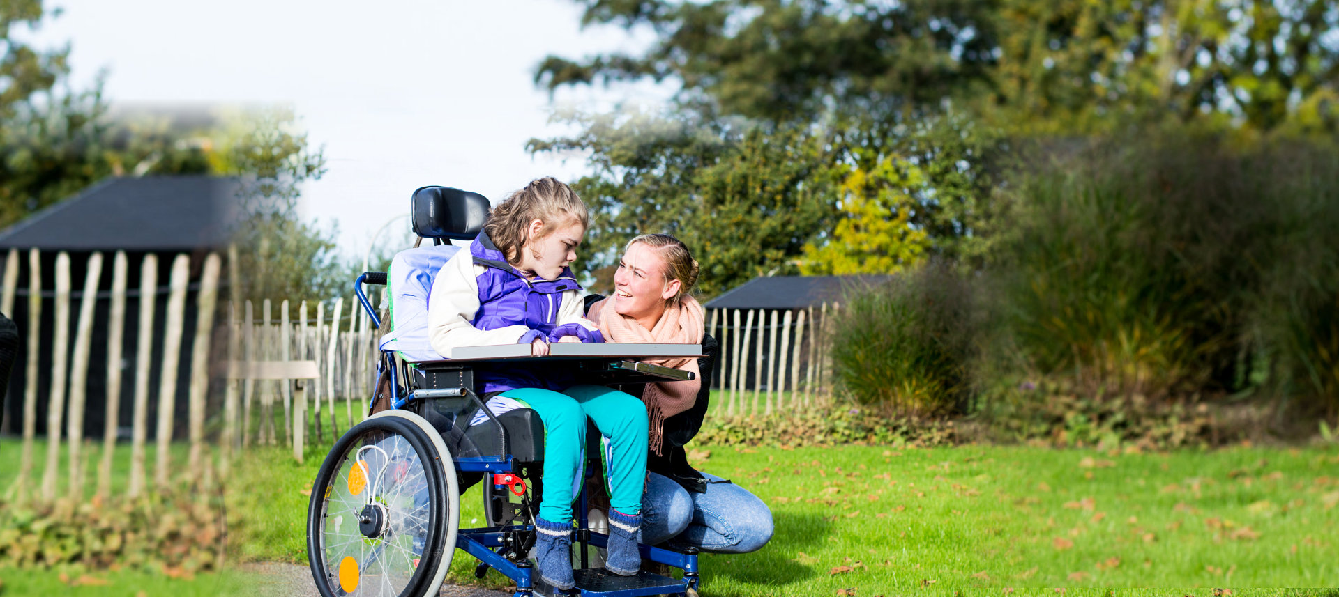 woman and girl with disability smiling